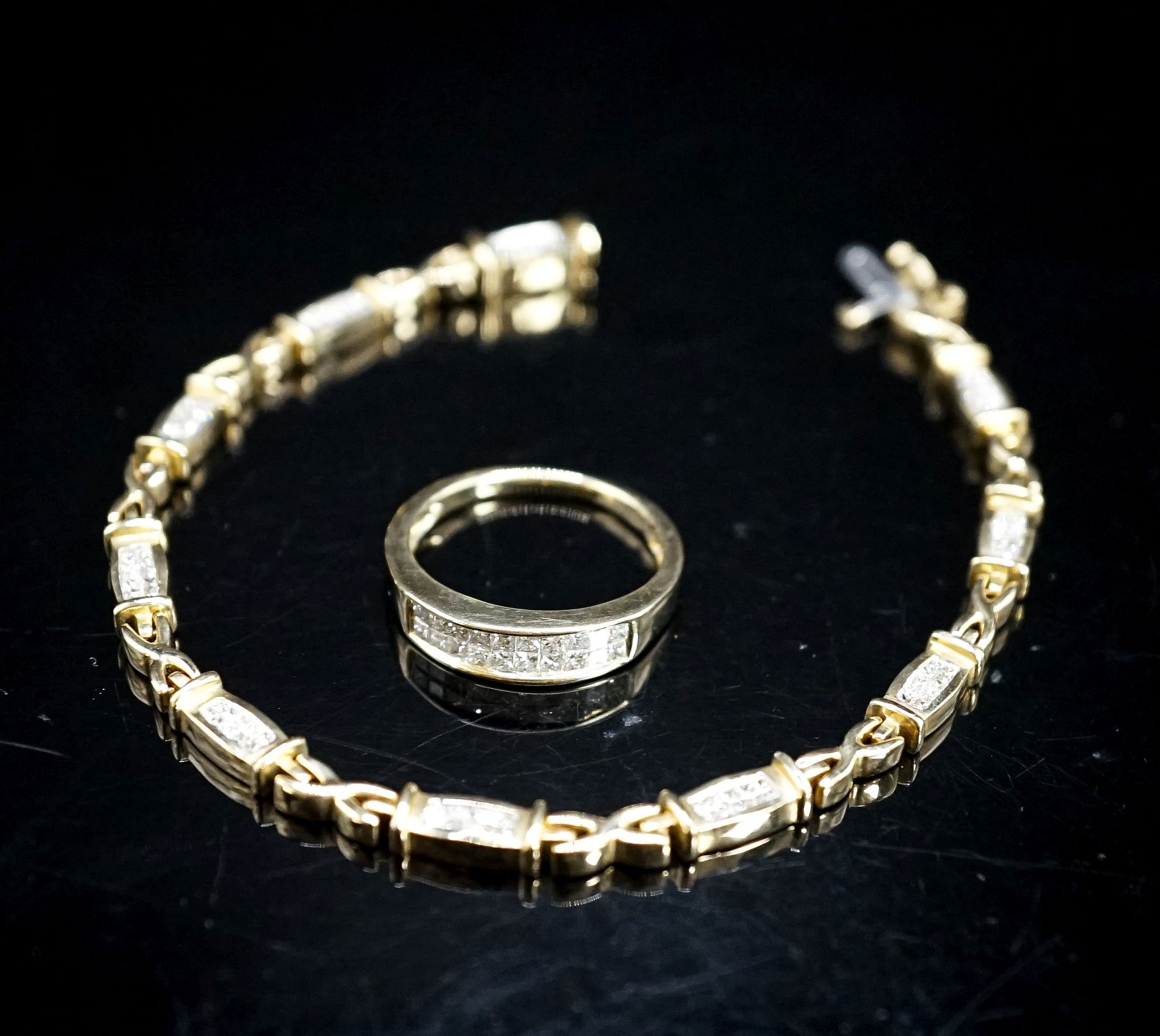 A modern 14k yellow metal and diamond chip set line bracelet, 18cm and a matching ring, size O/P, gross weight 17.2 grams.